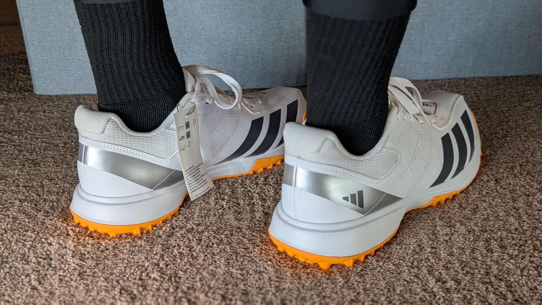 Howzat Spikeless Cricket shoes on feet from behind