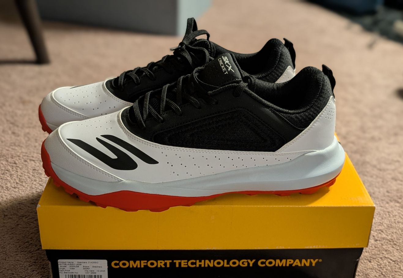 Red black skechers JQ8547 Cricket shoes from Amazon on box