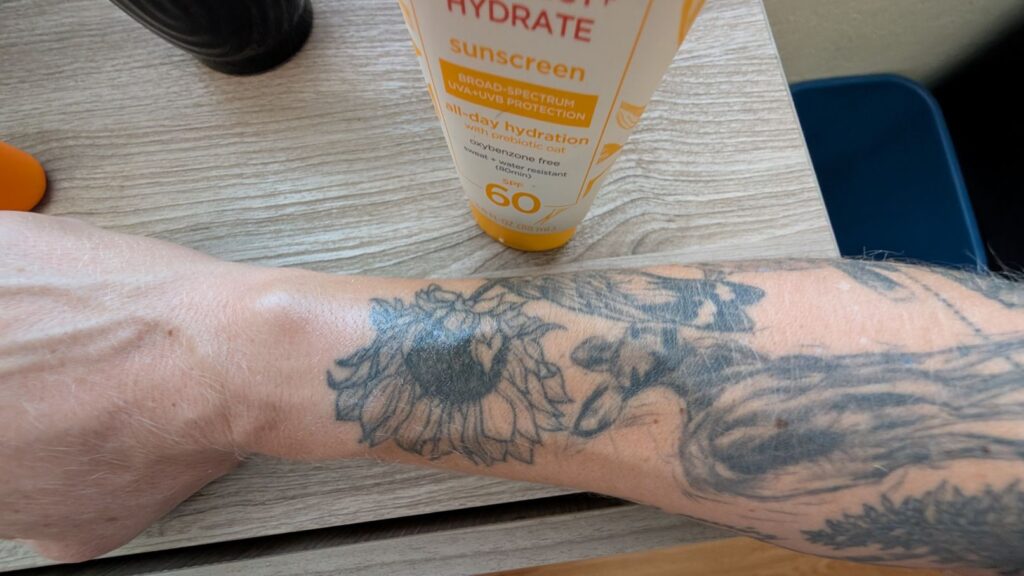 Aveeno Protect and Hydrate Sunscreen Consistency on arm tattoo
