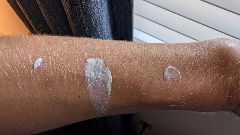 Aveeno Protect and Hydrate Sunscreen on skin next to Trader Joe's Daily facial sunscreen, La Roche Posay Mineral, and Banana Boat Sport.