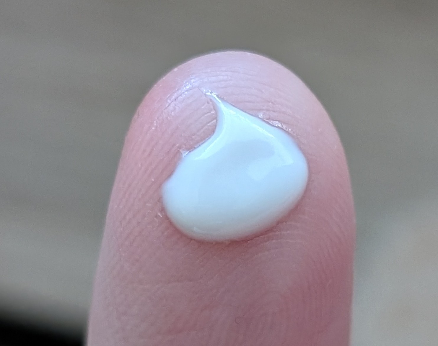 Close up of Banana Boat Sport sunscreen drop on finger.