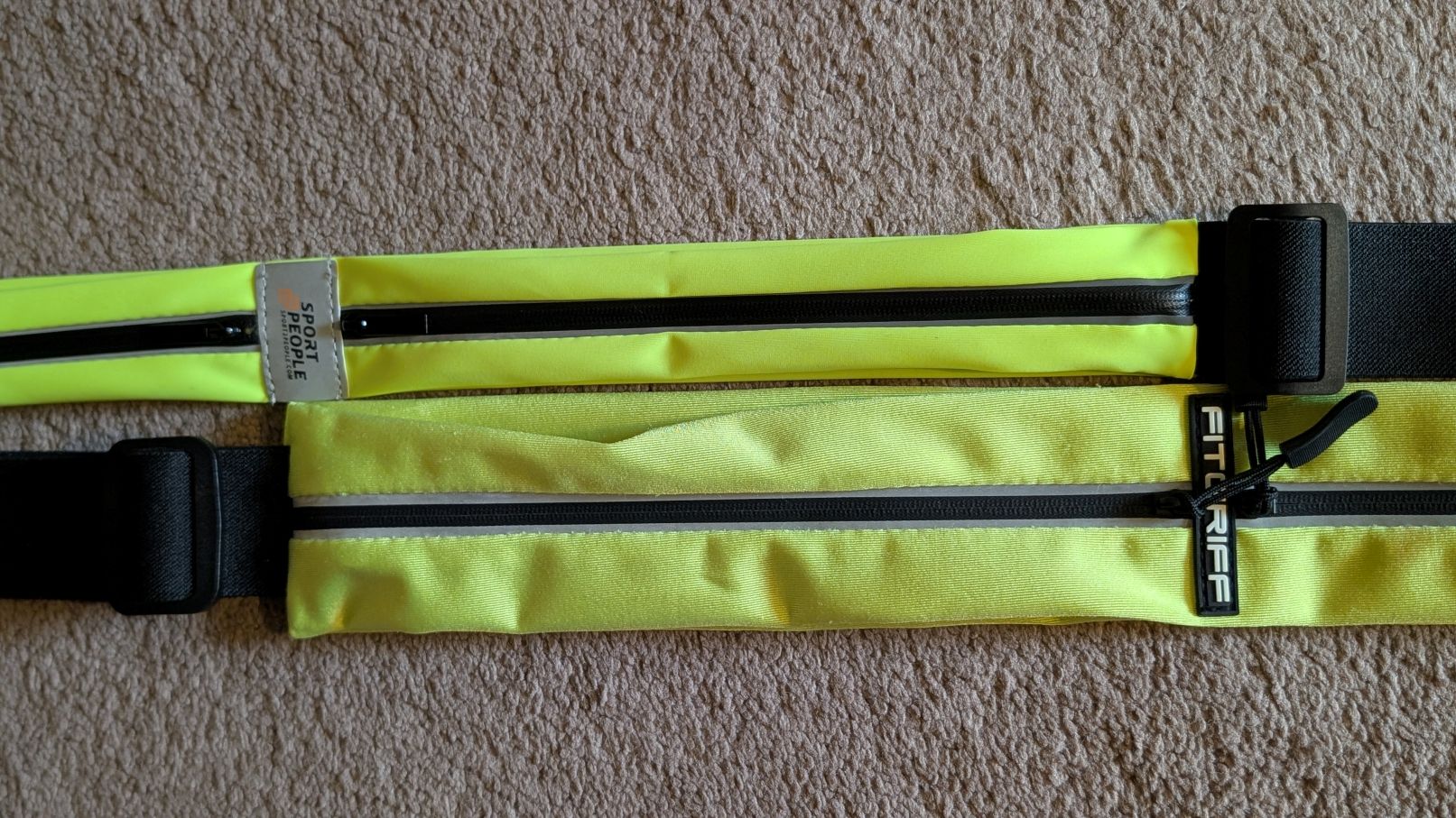 Yellow Fitgriff and Sport2People running belts side-by-side to compare large pocket size
