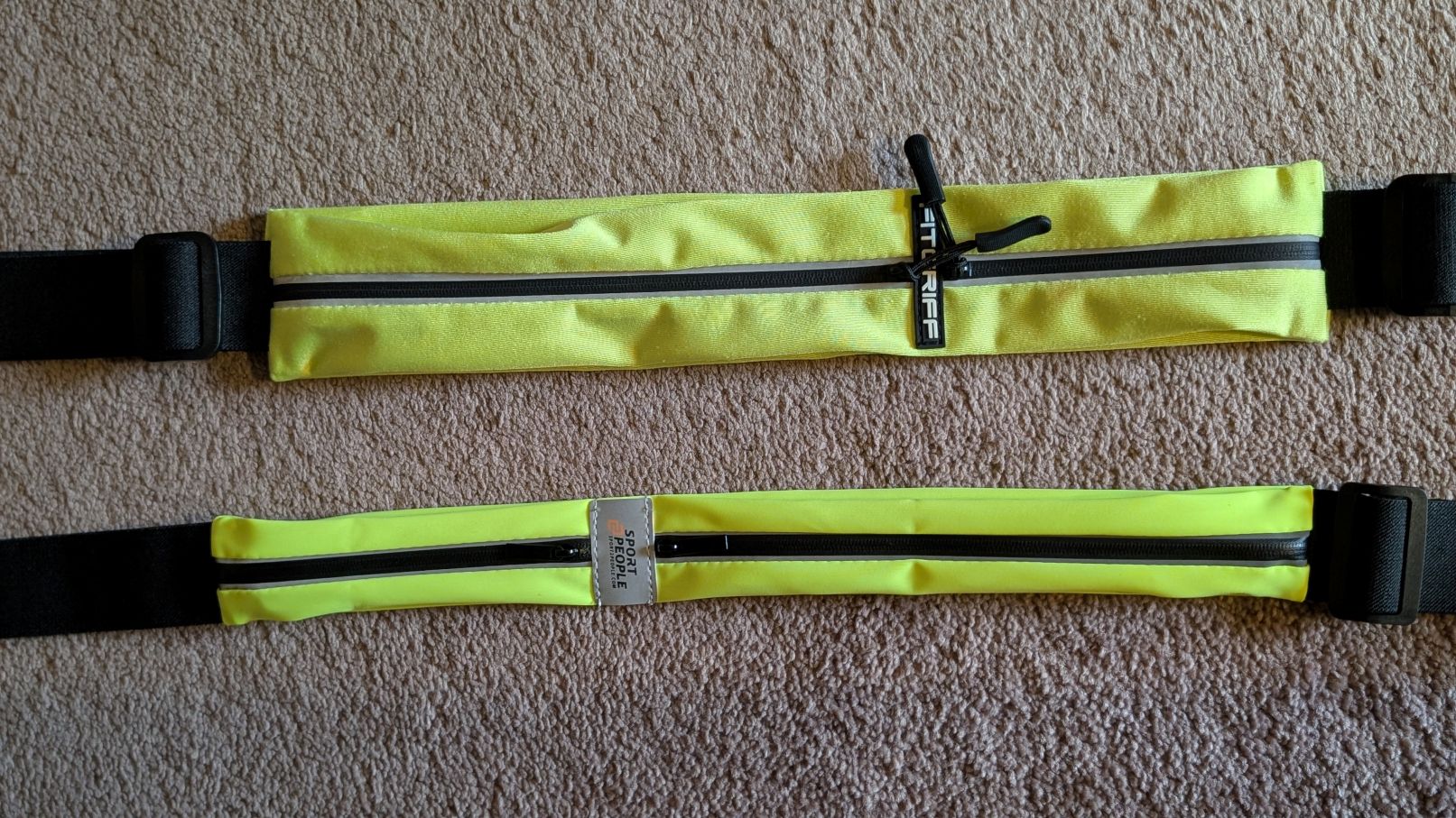 Sport2People running belt fluorescent yellow beside FitGrif running belt in yellow