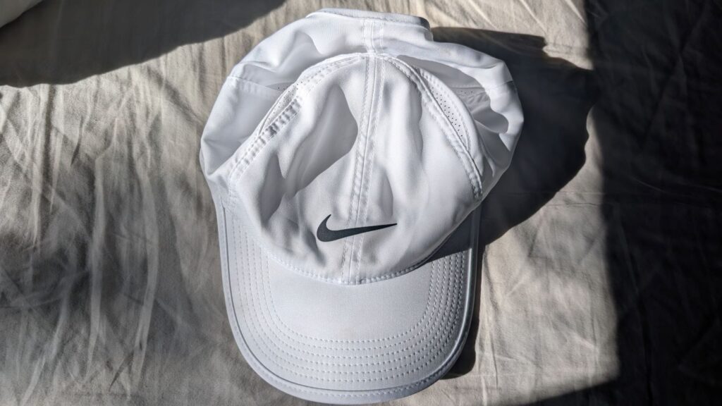 Top-down view of white Nike hat with unstructured top