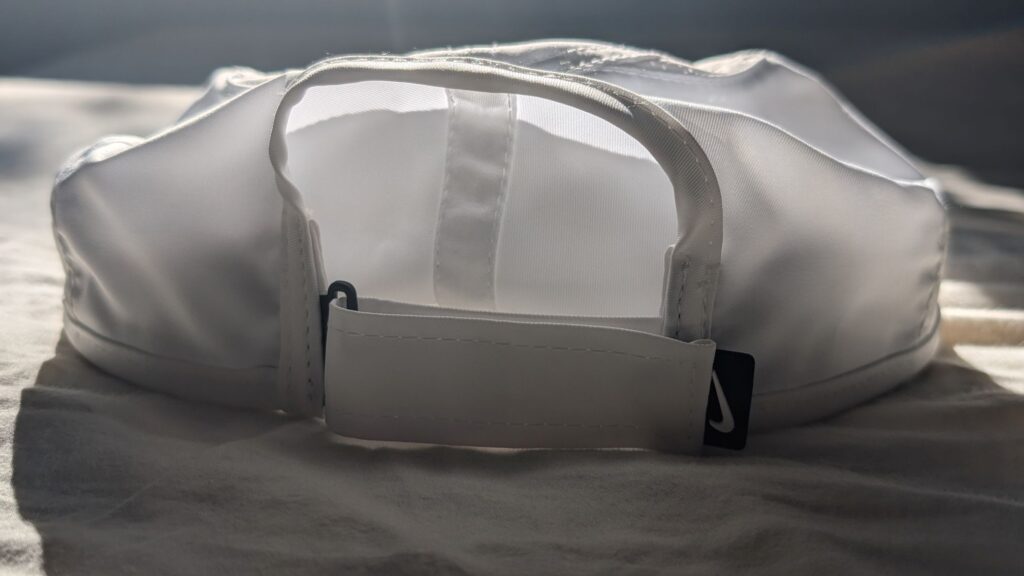 Up-close look at the back of the Nike Dri-FIT Club Unstructured Featherlight Cap Velcro Strap in white