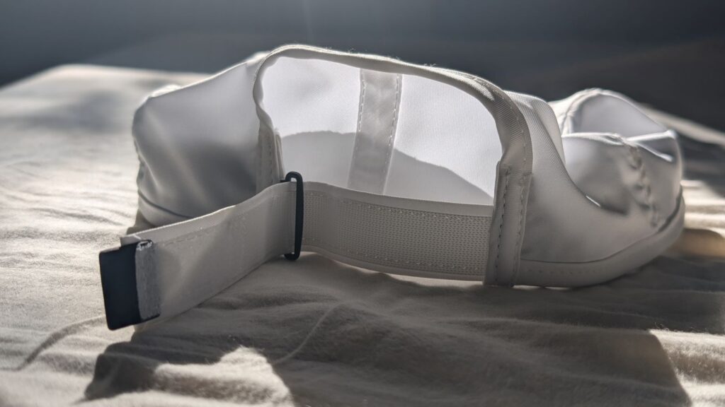 White Nike Dri-FIT Club Unstructured Featherlight running cap with Velcro closure opened.