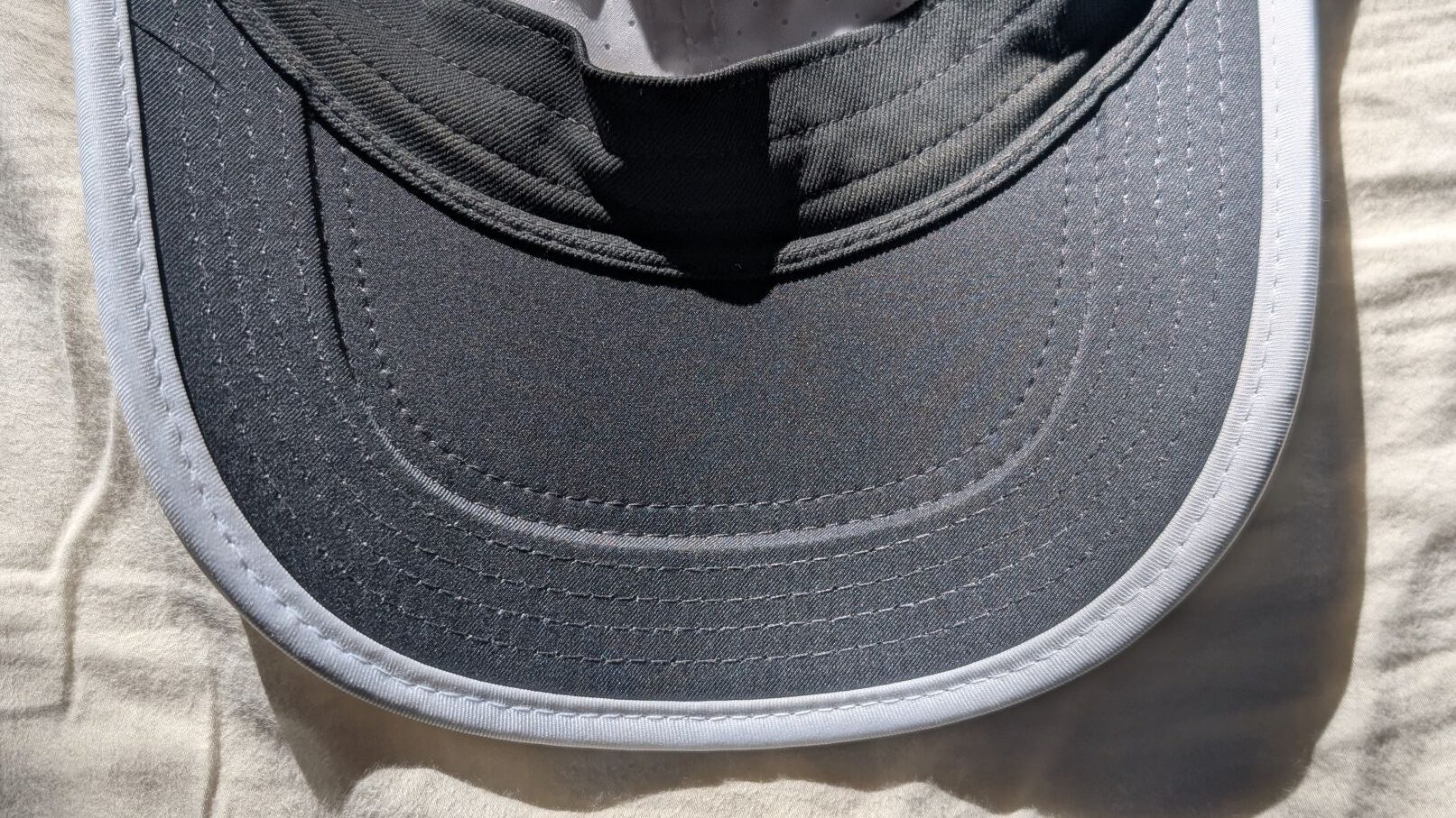Underside of Nike Dri-FIT Club Unstructured Featherlight Cap Visor in black