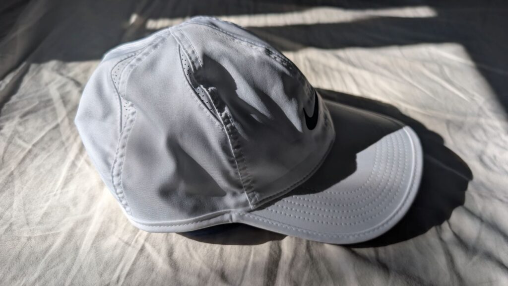 Nike Dri-FIT Club Unstructured Featherlight cap in white profile view of crown and visor