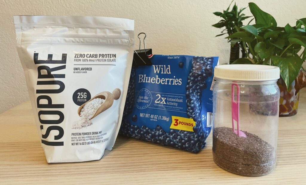 Bags of Isopure Zero Carb, frozen blueberries, and flax seeds for high protein smoothie recipe