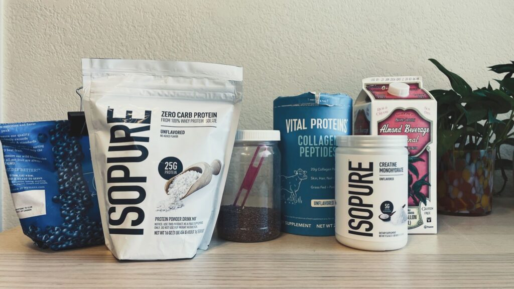 High protein smoothie recipe ingredients lined up including almond milk, creatine, and collagen powder.