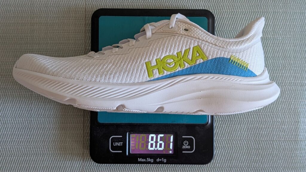 White running shoe on scale showing 8.61 ounces