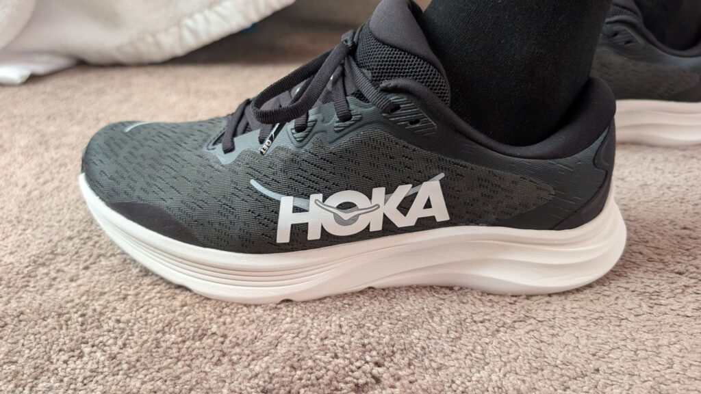 Lateral view of Hoka Solimar 2 black trainer on foot
