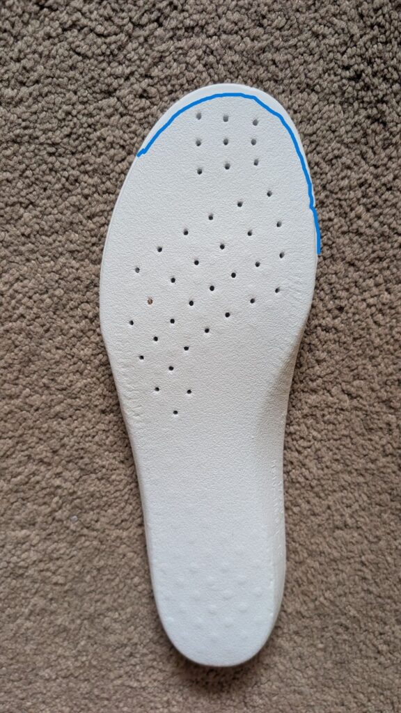 Blue line on white insole showing how much bigger the Hoka Solimar 2 is