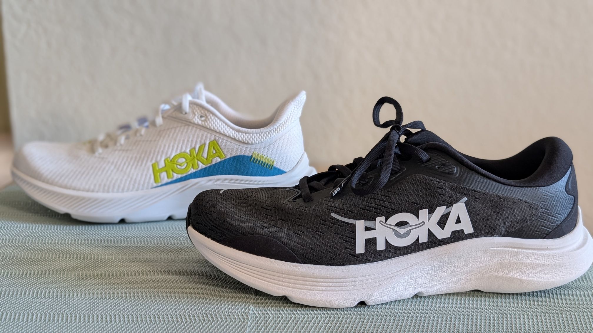Review of black and white Hoka Solimar 2 shoe next to white Solimar 2 trainer