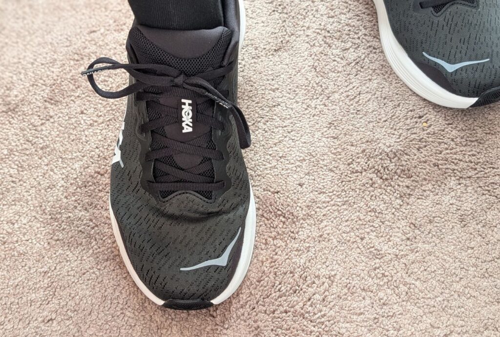 Hoka Solimar 2 in Black and White on foot with large silver logo