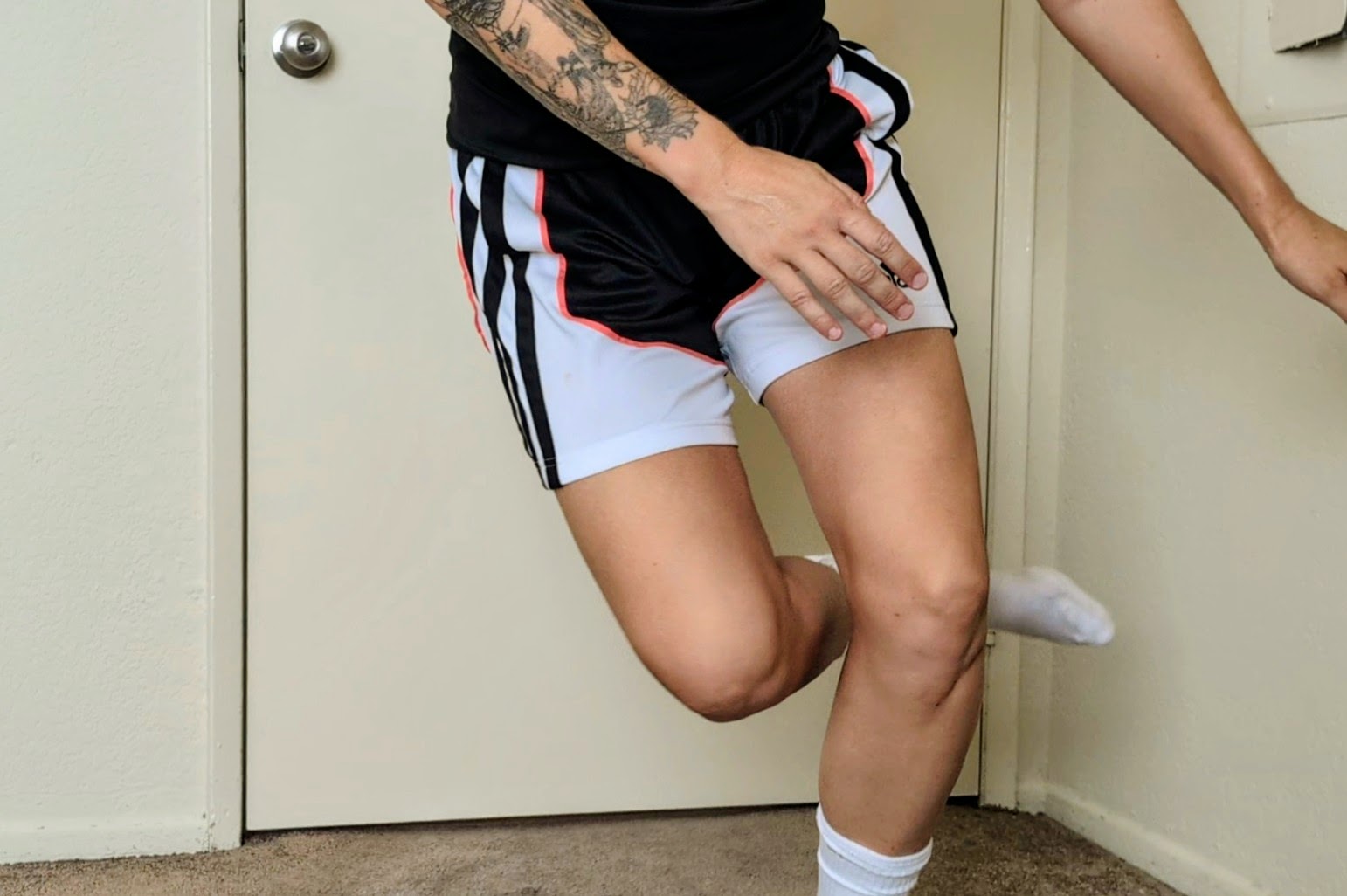 Athlete doing skater hops quad strain exercises to rehab thigh muscle injury