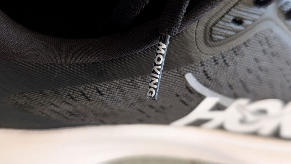 Close up of Hoka shoelace with the word Moving printed on the lace end