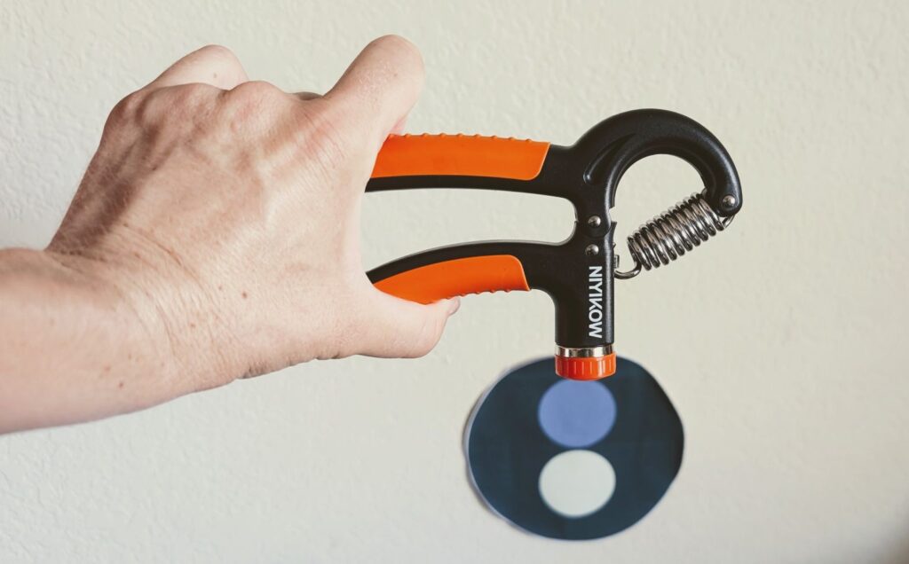 Hand squeezing orange Niyikow grip strength cricket training equipment