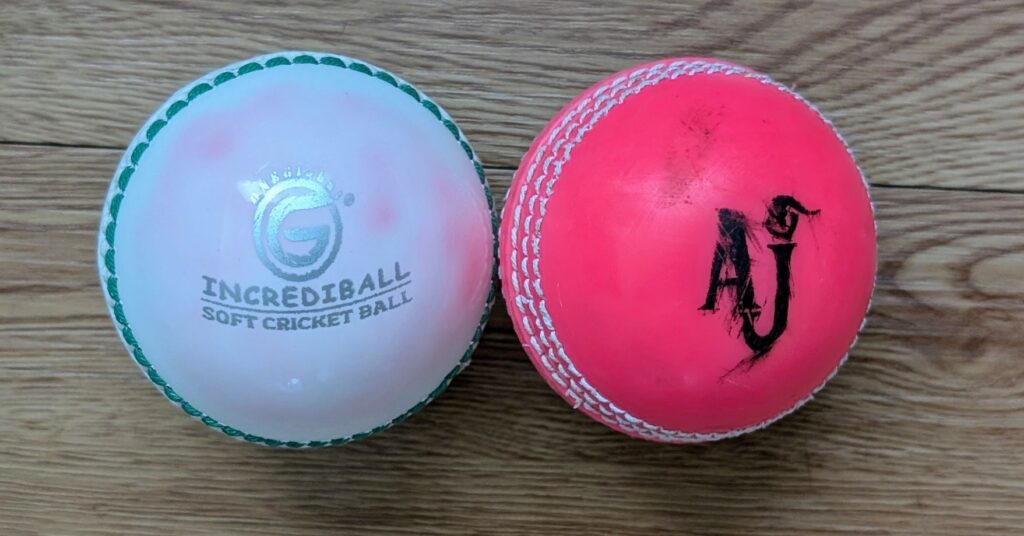 White and pink synthetic cricket balls size comparison.