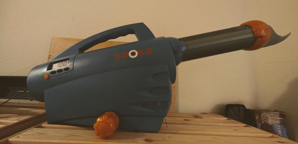 Zooka portable pitching machine used as cricket training equipment for outdoor batting practice 