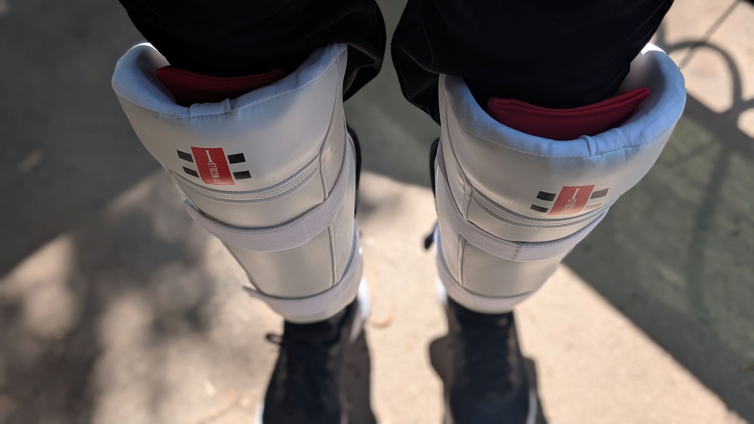 Athlete wearing Gray Nicholls cricket pads in field-tested sporting goods review