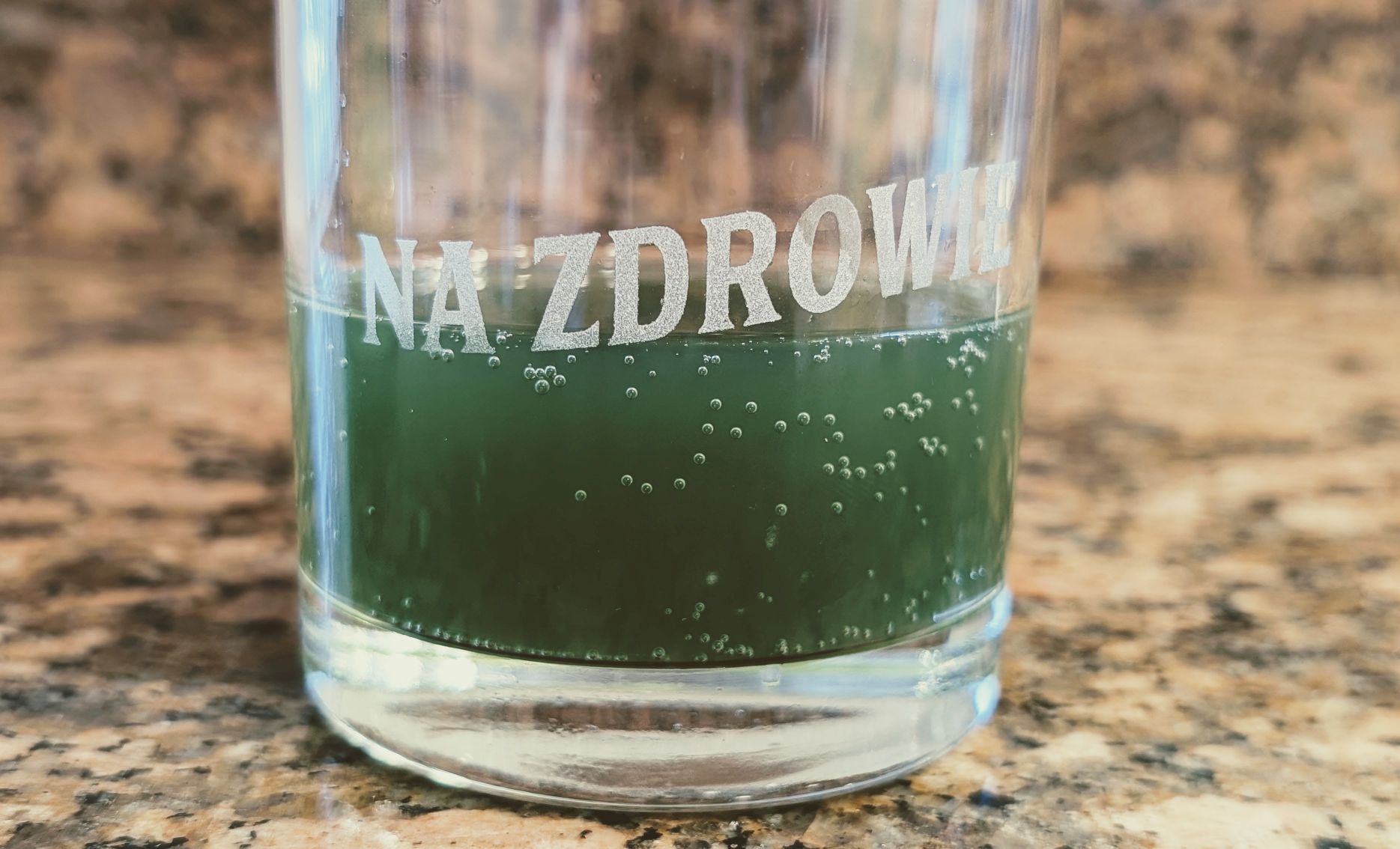 Green drink in glass poured for functional beverages review