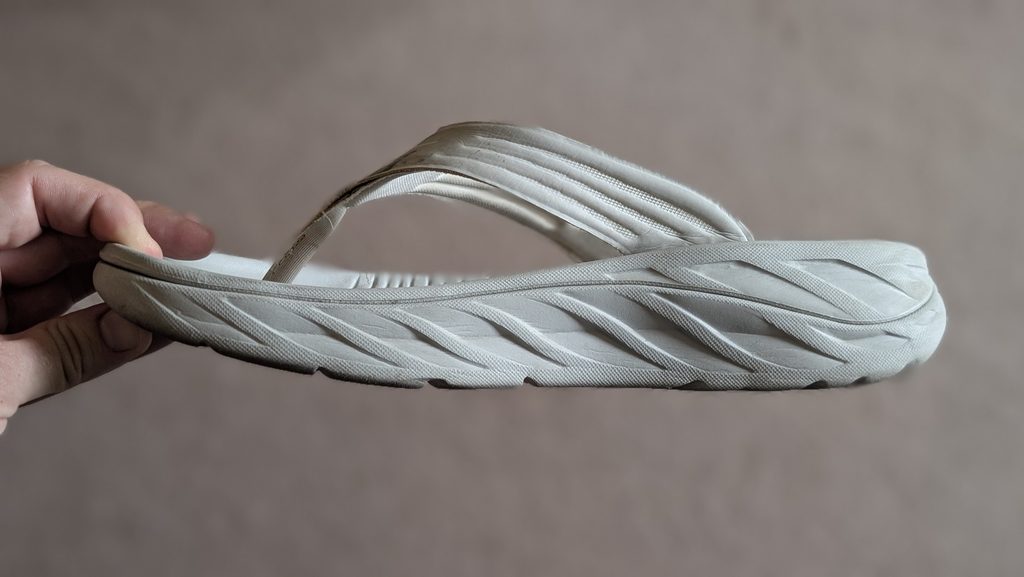 Side view of white Hoka Ora Recovery Flip flops Metarocker technology