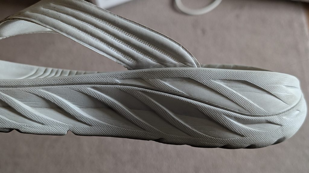 Side view of white Hoka Ora Recovery Flip Flops midsole