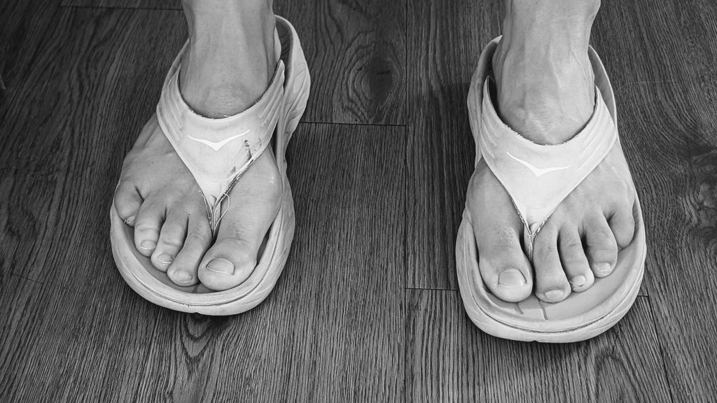 White Hoka Ora Recovery Flip Flops on feet 