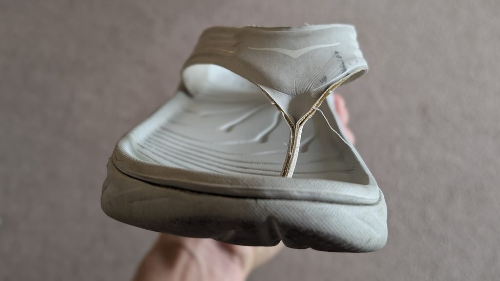 Close-up of Hoka recovery sandals wear and tear after two years